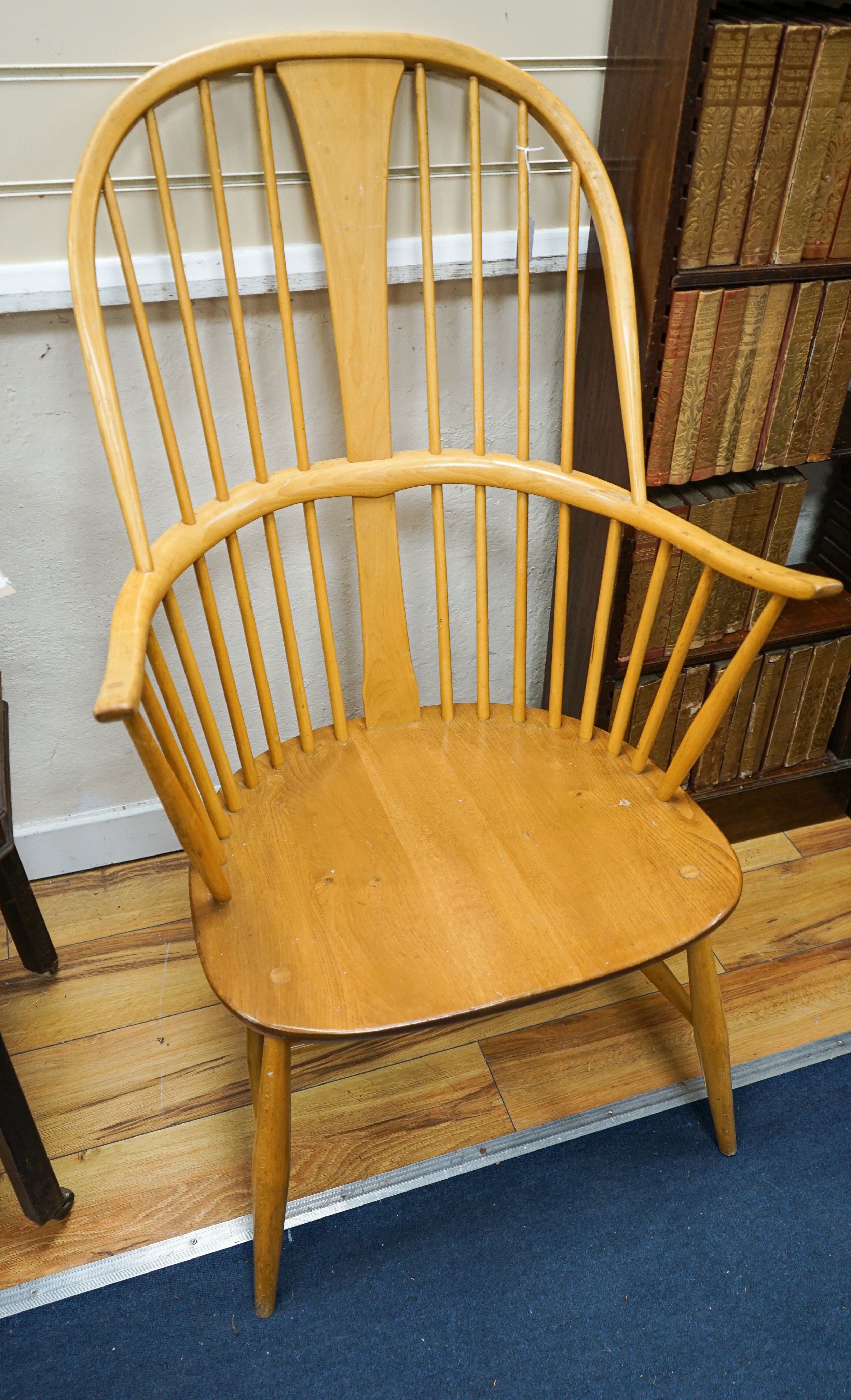 An Ercol light elm and beech comb back Windsor armchair